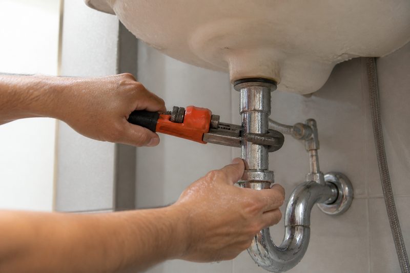 Plumber repairing a pipe